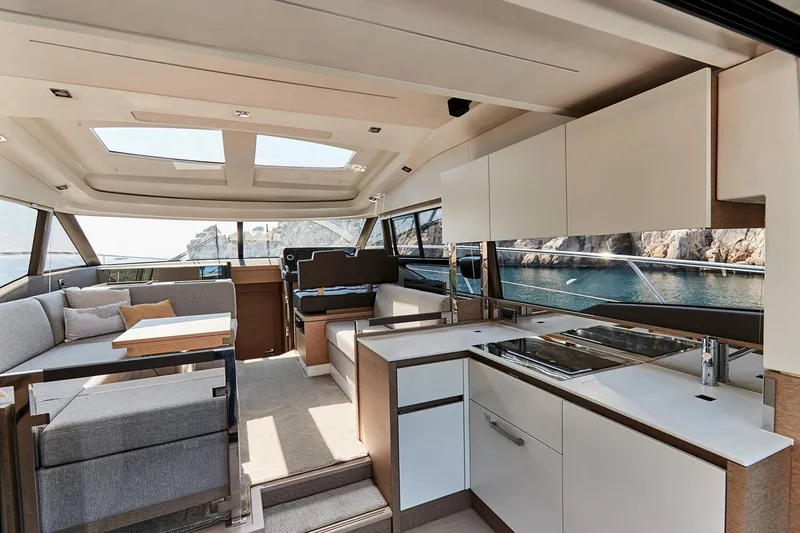 Slide: The Image of Manufacturer Provided Image: Luxurious interior of 2025 Prestige 460 S yacht with modern kitchen and seating area. - 13