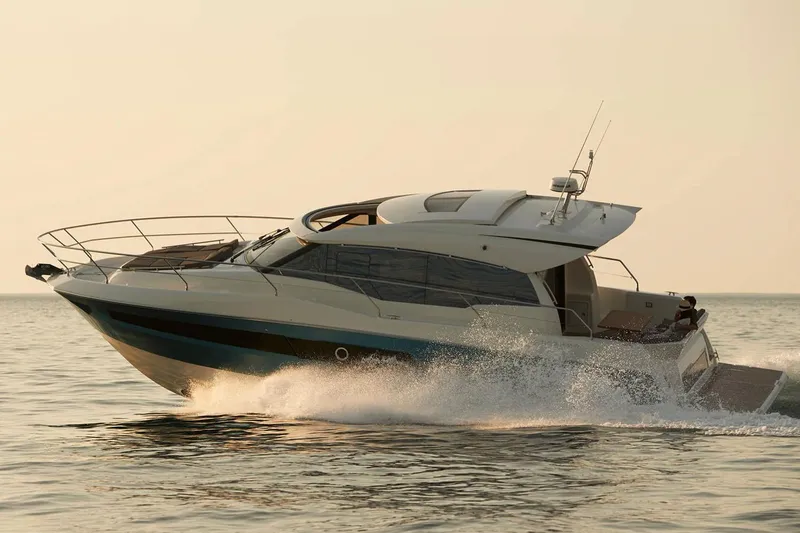 Slide: The Image of Manufacturer Provided Image: 2025 Prestige 460 S yacht cruising on open water at sunset. - 3