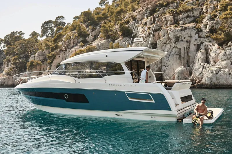 Slide: The Image of Manufacturer Provided Image: 2025 Prestige 460 S yacht anchored near rocky coastline. - 5