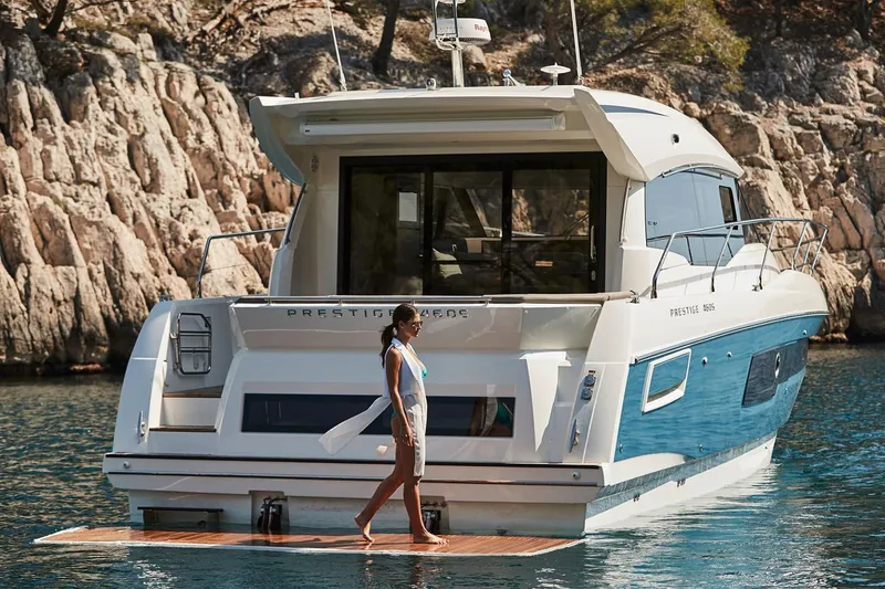 Slide: The Image of Manufacturer Provided Image: Woman on 2025 Prestige 460 S yacht in scenic coastal waters. - 7