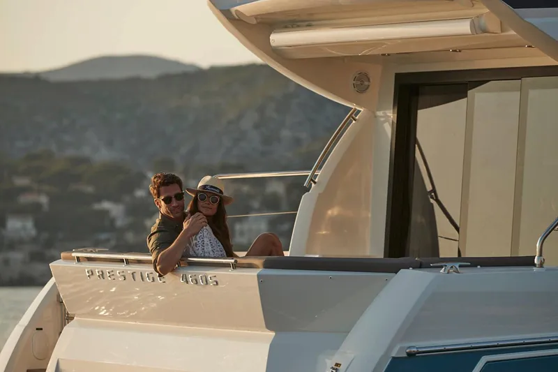 Slide: The Image of Manufacturer Provided Image: Couple relaxing on 2025 Prestige 460 S yacht at sunset. - 8