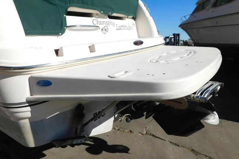 Slide: The Image of 2001 Chaparral Signature 240 boat with swim platform and green cover. - 10