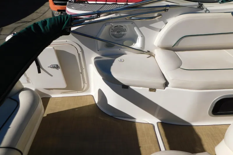 Slide: The Image of 2001 Chaparral Signature 240 boat interior with white seating and storage compartment. - 13