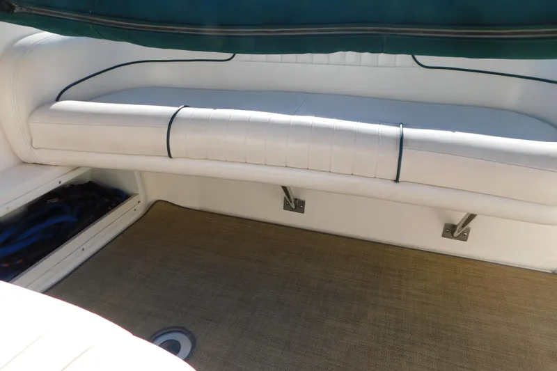 Slide: The Image of 2001 Chaparral Signature 240 boat interior with white seating and storage compartment. - 15