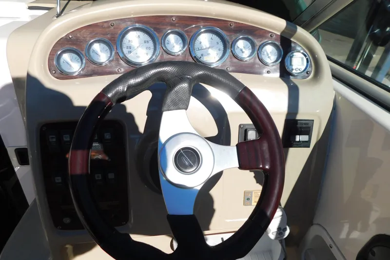 Slide: The Image of 2001 Chaparral Signature 240 dashboard with steering wheel and gauges. - 18