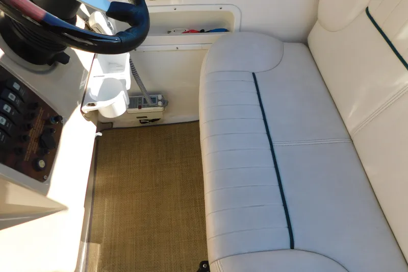 Slide: The Image of 2001 Chaparral Signature 240 boat interior with steering wheel and cushioned seating. - 19