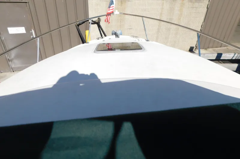 Slide: The Image of 2001 Chaparral Signature 240 boat deck with American flag in marina setting. - 21