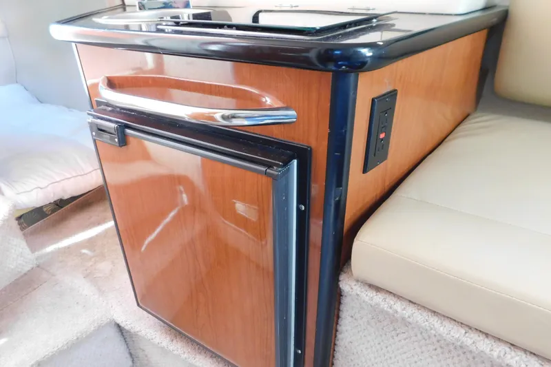 Slide: The Image of 2001 Chaparral Signature 240 interior with wood-finish kitchenette and mini fridge. - 27