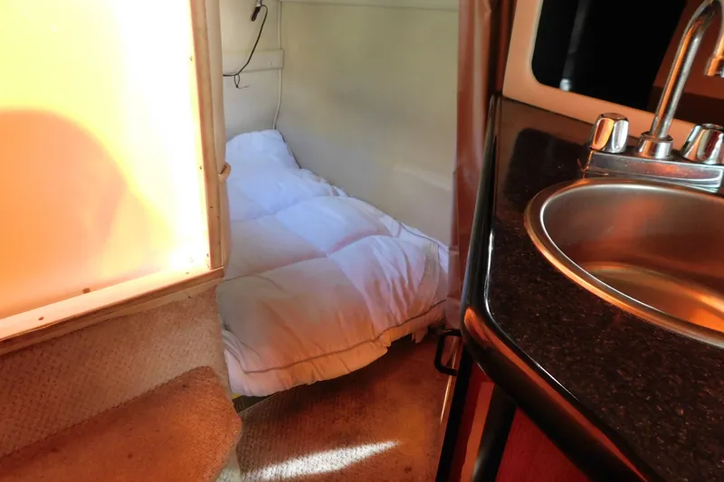 Slide: The Image of Interior of 2001 Chaparral Signature 240 boat with bed and sink. - 28