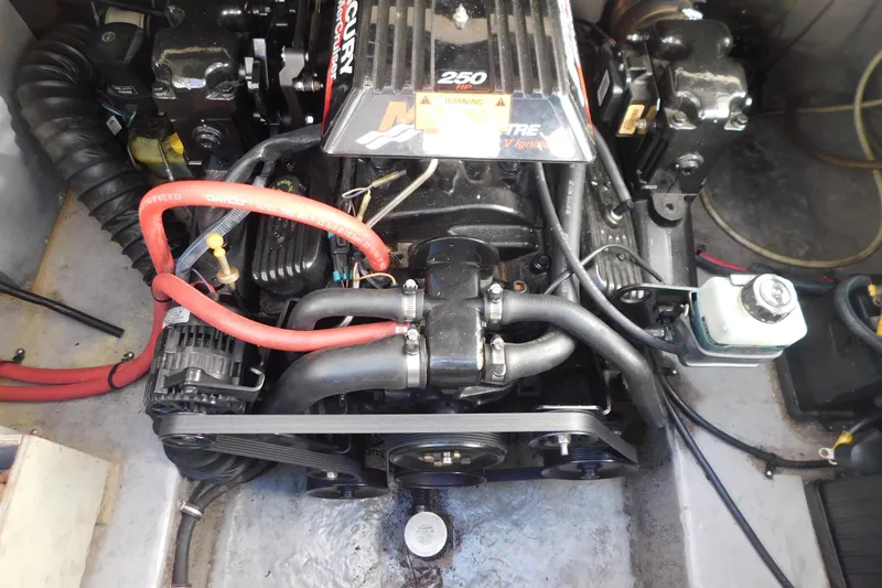 Slide: The Image of Engine compartment of a 2001 Chaparral Signature 240 boat, featuring a Mercury 250 HP engine. - 32