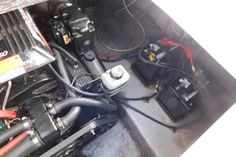 Slide: The Image of Engine compartment of 2001 Chaparral Signature 240 with visible batteries and wiring. - 33