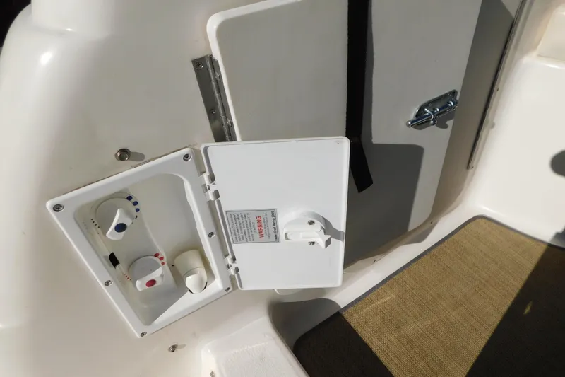 Slide: The Image of Control panel on 2001 Chaparral Signature 240 boat, featuring knobs and warning label. - 35