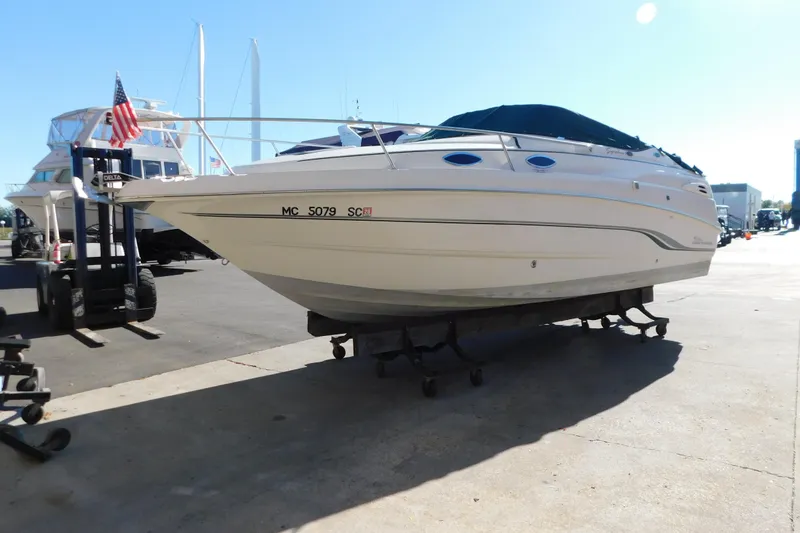 The Image of 2001 Chaparral Signature 240 boat on trailer, docked in marina under clear sky. - 5