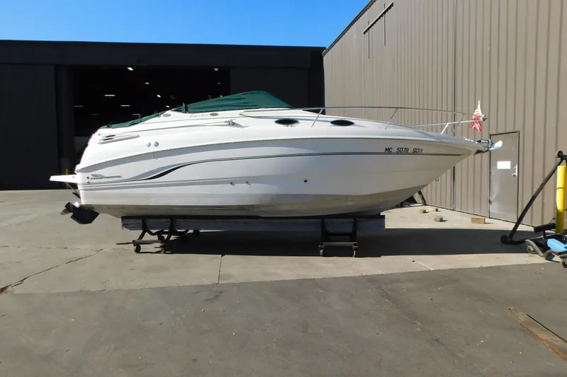 Slide: The Image of 2001 Chaparral Signature 240 boat on trailer, parked outside a large building. - 7