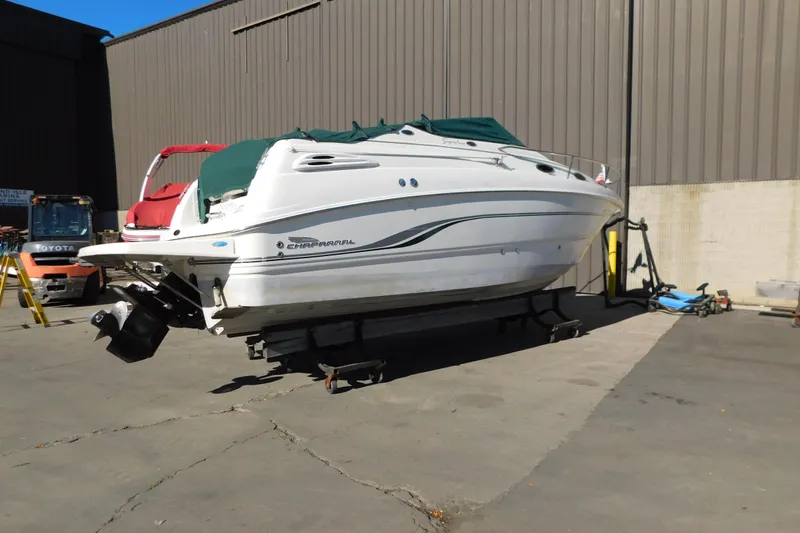 Slide: The Image of 2001 Chaparral Signature 240 boat on trailer in industrial setting. - 9