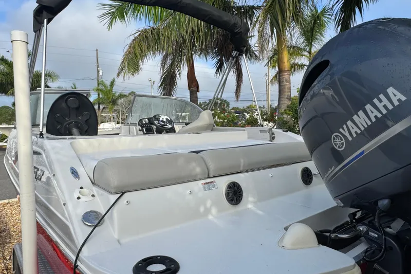 Slide: The Image of 2019 Starcraft MDX 210 OB boat with Yamaha outboard motor, parked near palm trees. - 11