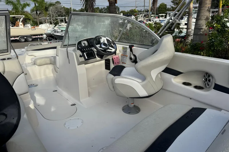 Slide: The Image of 2019 Starcraft MDX 210 OB boat interior with steering wheel and seating. - 13