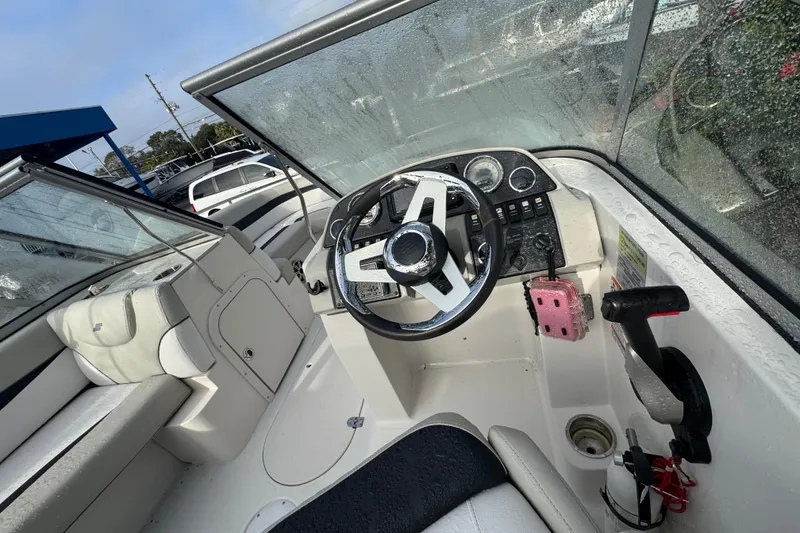 Slide: The Image of 2019 Starcraft MDX 210 OB boat interior with steering wheel and seating. - 18