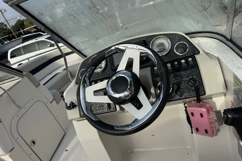 Slide: The Image of Steering console of a 2019 Starcraft MDX 210 OB boat, featuring controls and gauges. - 19