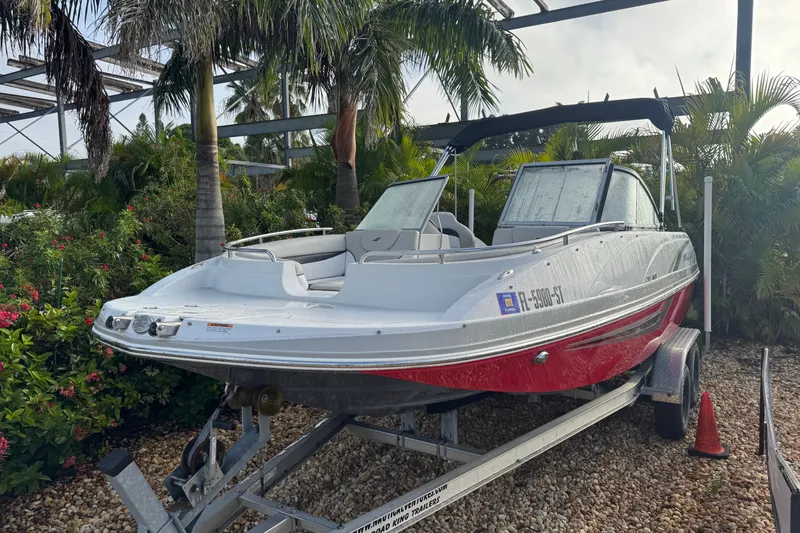 Slide: The Image of 2019 Starcraft MDX 210 OB boat on trailer, surrounded by tropical plants. - 3