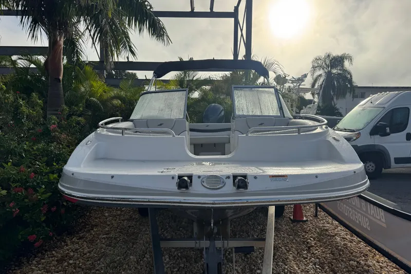 Slide: The Image of 2019 Starcraft MDX 210 OB boat on display, surrounded by tropical plants and parked vehicles. - 4