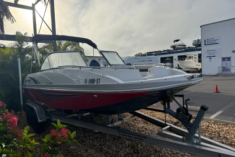 Slide: The Image of 2019 Starcraft MDX 210 OB boat on trailer, parked near service department entrance. - 5