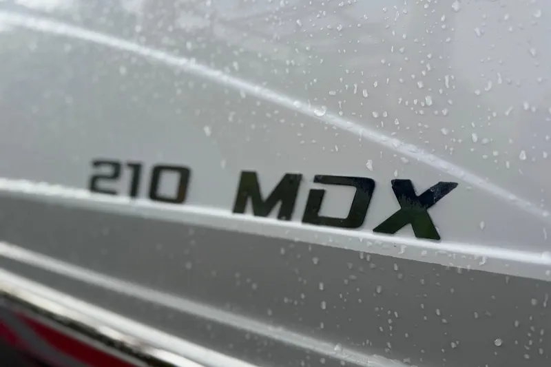 Slide: The Image of Close-up of 2019 Starcraft MDX 210 OB boat model name with water droplets. - 7