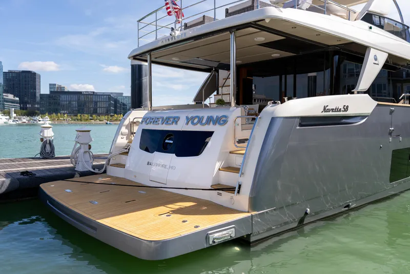 Slide: The Image of Luxury 2018 Absolute 58 Navetta yacht docked in a marina, rear view. - 11