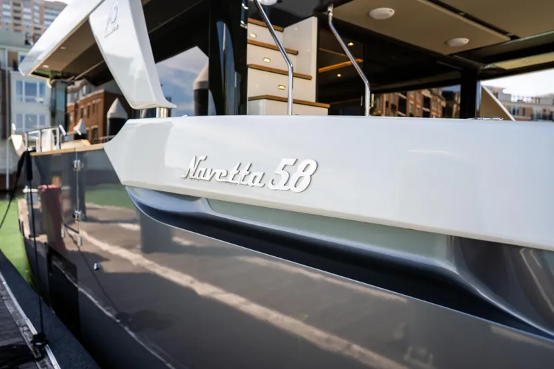 Slide: The Image of 2018 Absolute 58 Navetta yacht docked, showcasing sleek design and modern features. - 12