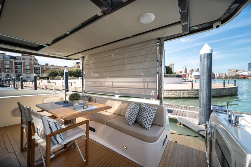 Slide: The Image of Luxurious 2018 Absolute 58 Navetta yacht with elegant outdoor seating and waterfront view. - 13
