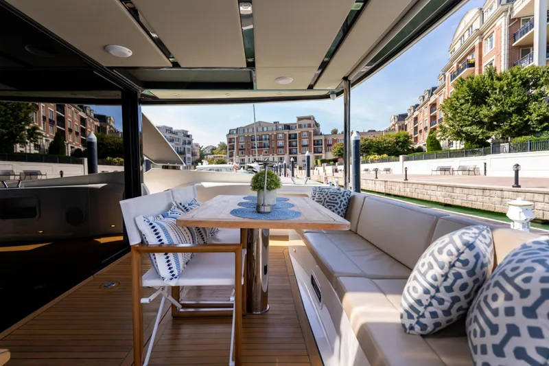 Slide: The Image of Luxurious 2018 Absolute 58 Navetta yacht with elegant outdoor seating and scenic marina view. - 14