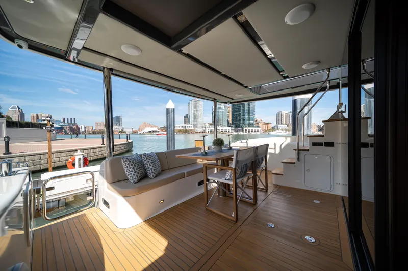 Slide: The Image of Luxurious 2018 Absolute 58 Navetta yacht deck with seating and waterfront view. - 15