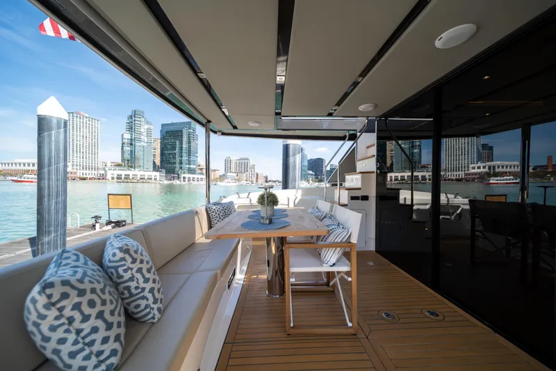 Slide: The Image of Luxurious 2018 Absolute 58 Navetta yacht deck with city skyline view. - 16