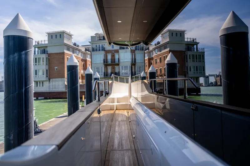 Slide: The Image of Luxury Absolute 58 Navetta yacht docked near waterfront buildings, 2018 model. - 17