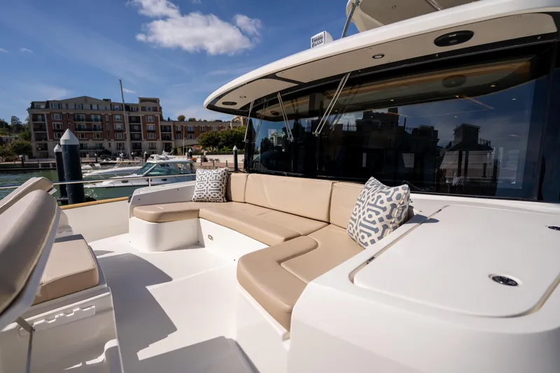 Slide: The Image of Luxurious seating area on 2018 Absolute 58 Navetta yacht, docked near waterfront buildings. - 18