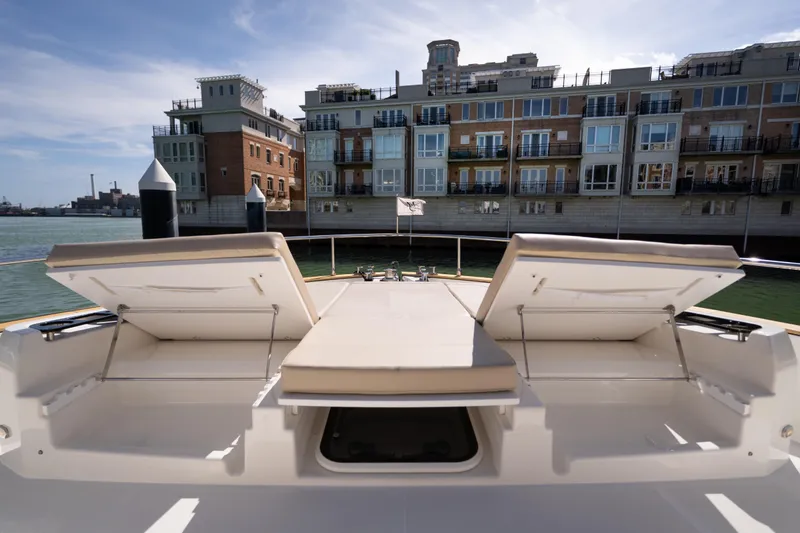 Slide: The Image of Luxurious 2018 Absolute 58 Navetta yacht docked near waterfront buildings. - 19