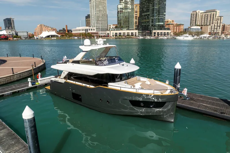 Slide: The Image of Luxury 2018 Absolute 58 Navetta yacht docked in urban marina setting. - 2
