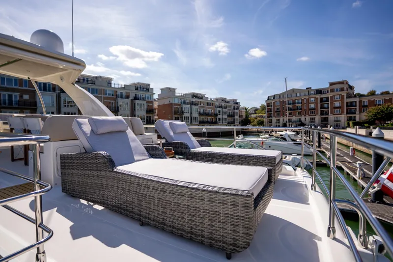 Slide: The Image of Luxurious 2018 Absolute 58 Navetta yacht with sun loungers in a marina setting. - 23