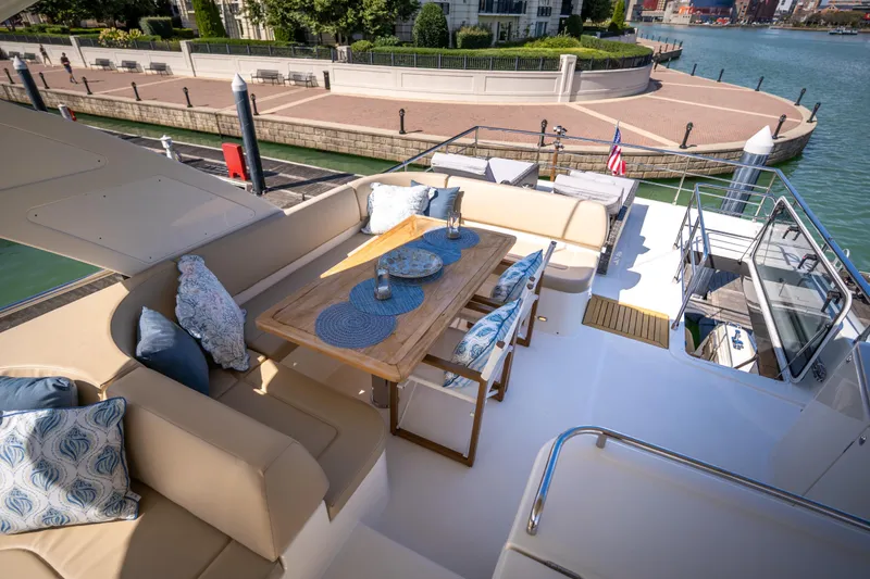 Slide: The Image of Luxurious 2018 Absolute 58 Navetta yacht deck with elegant seating and dining area. - 25
