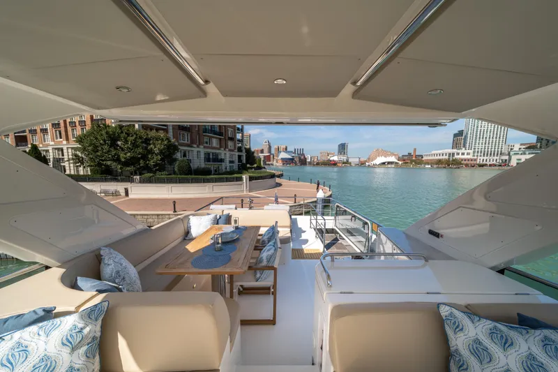 Slide: The Image of Luxurious 2018 Absolute 58 Navetta yacht with elegant outdoor seating and scenic waterfront view. - 33