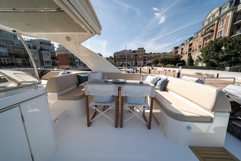 Slide: The Image of Luxurious 2018 Absolute 58 Navetta yacht deck with elegant seating and scenic waterfront view. - 38