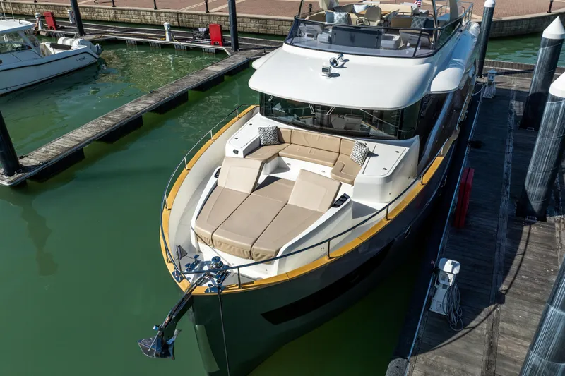 Slide: The Image of Luxurious 2018 Absolute 58 Navetta yacht docked, featuring spacious sunbathing area and elegant design. - 4