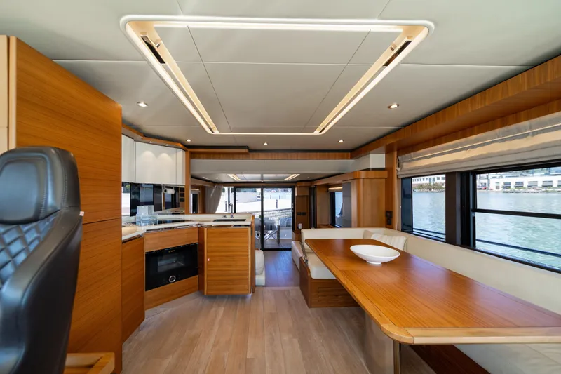 Slide: The Image of Luxurious interior of 2018 Absolute 58 Navetta yacht with modern wood finishes and spacious seating. - 48