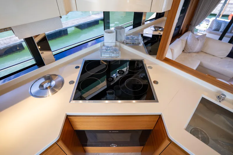 Slide: The Image of Modern kitchen on 2018 Absolute 58 Navetta yacht with sleek cooktop and luxurious interior. - 52