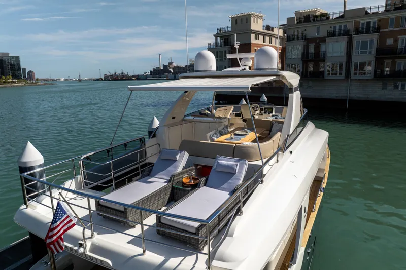 Slide: The Image of Luxury 2018 Absolute 58 Navetta yacht docked, featuring spacious deck and elegant design. - 6