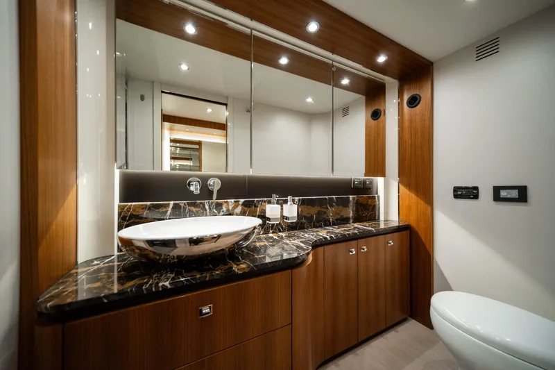 Slide: The Image of Luxurious bathroom in 2018 Absolute 58 Navetta yacht with elegant wood and marble finishes. - 63