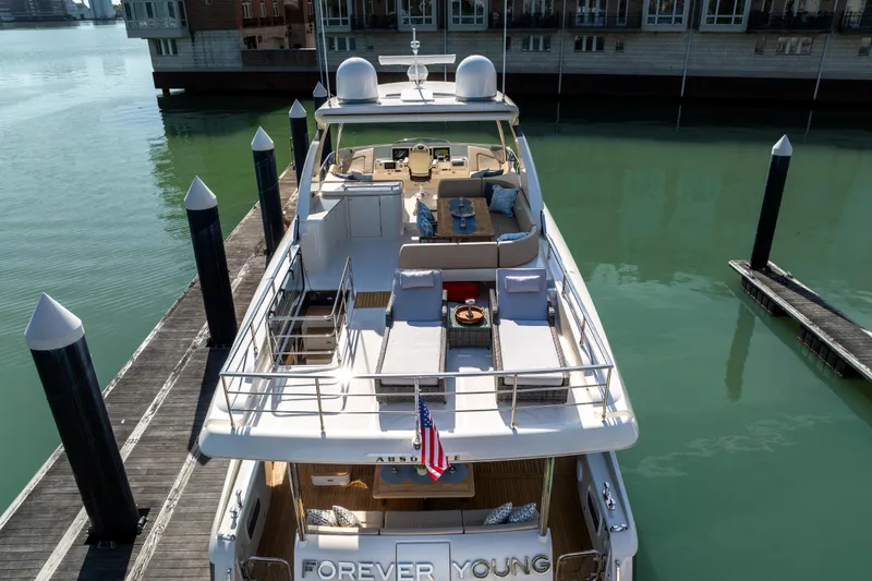 Slide: The Image of Luxurious 2018 Absolute 58 Navetta yacht docked, featuring spacious deck and elegant design. - 7