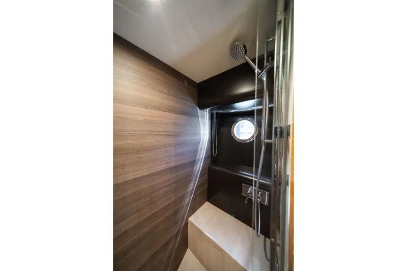 Slide: The Image of Luxurious shower interior of 2018 Absolute 58 Navetta yacht with wood paneling and porthole. - 71