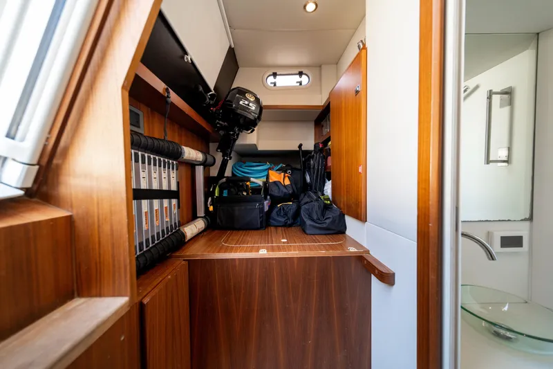 Slide: The Image of Storage area in 2018 Absolute 58 Navetta yacht with equipment and wooden cabinetry. - 73