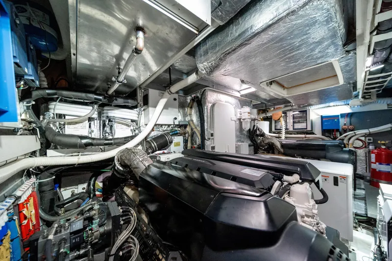 Slide: The Image of Engine room of 2018 Absolute 58 Navetta yacht, showcasing complex machinery and piping. - 75